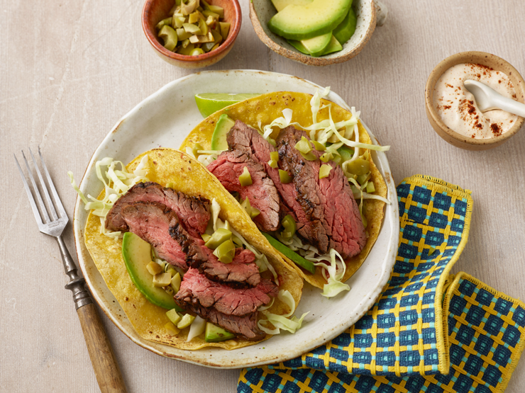 steak tacos on a plate with chipotle cream