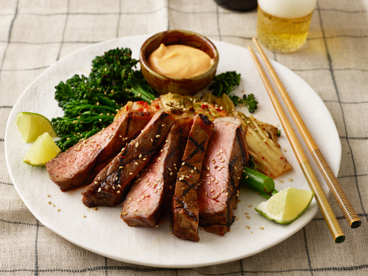 korean steak served with kimchi and broccoli