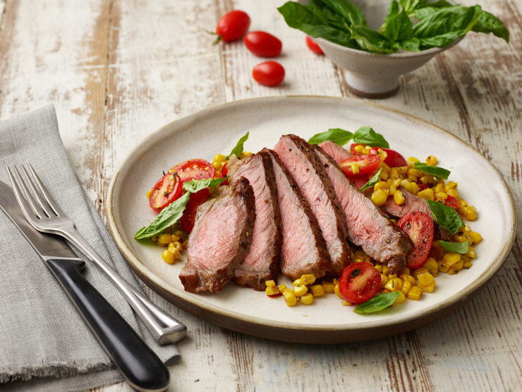 grilled ribeye plated with corn